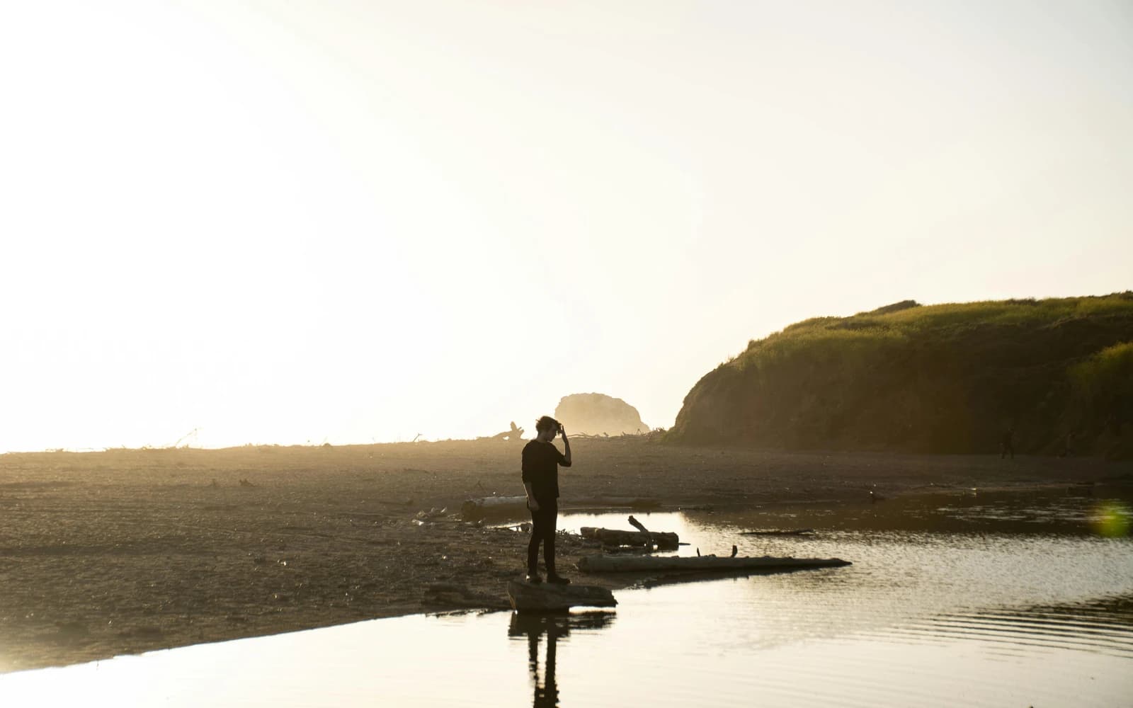 Person overlooking the horizon at golden hour