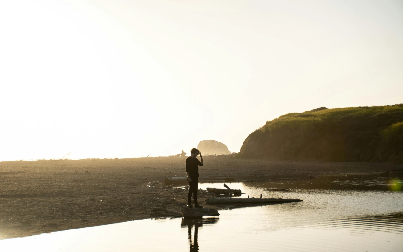 Person overlooking the horizon at golden hour